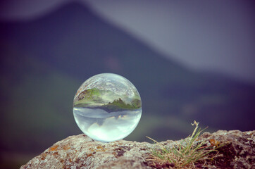 Crystal lensball in nature on the rock, glass ball