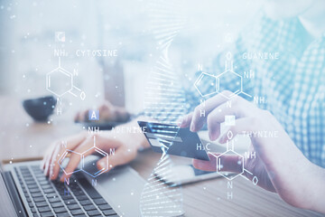 Double exposure of man hands holding a credit card and DNA drawing. On-line Education and...