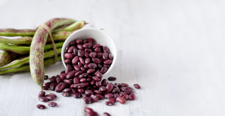 Fototapeta na wymiar Beans are red on a white background. The concept of healthy vegetarian food with copying space