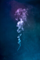 Abstract colorful smoke on black background .
