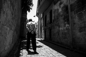 person walking in the street, black and white. 
