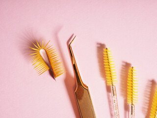 False eyelashes and brushes for the master, there is a pair of tweezers nearby