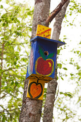 funny ornate birdhouse hanging on a tree