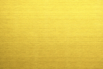Fototapeta premium Shiny gold polished metal background texture of brushed stainless steel plate with the reflection of light.