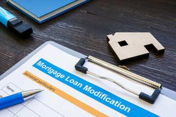 Mortgage loan modification application with pen and notepad. - obrazy, fototapety, plakaty