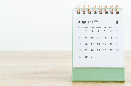 August Calendar 2021 on wooden table.