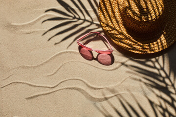 Fototapeta na wymiar Traveler vacation accessories on beach sand. Flat lay, top view.