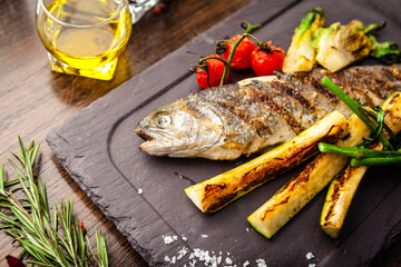 Rainbow trout grilled. Vegetables, white wine sauce. Delicious healthy traditional food closeup served for lunch in modern gourmet cuisine restaurant