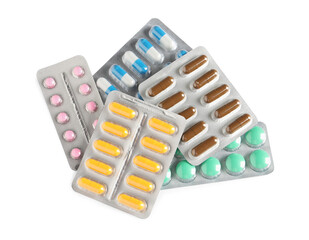 Blisters with different pills on white background, top view