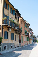 Fototapeta na wymiar Portrait format view of a small Italian town showing pastoral buildings shutters and balconies
