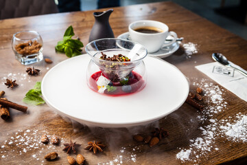 Raspberry-pistachio paradise island. Pistachio cream, raspberry panna cotta, almond-pistachio. Delicious healthy traditional food closeup served for lunch in modern gourmet cuisine restaurant