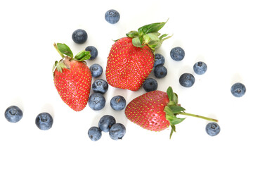 Summer berries. Strawberries and blueberries on light background