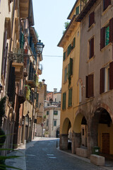 Fototapeta na wymiar A typical narrow Italian Street in attractive small town