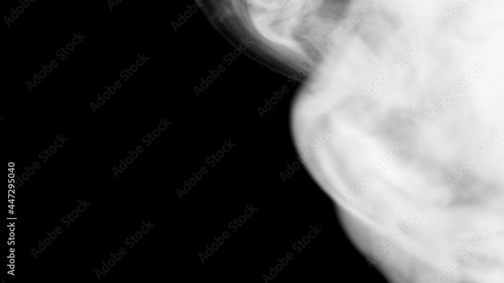 Wall mural bright white smoke smoke on a black background slow motion. the start of movement of the clouds from