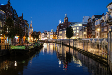 Sunset in the City of Amsterdam with colorfull reflections on the water, Amsterdam, Netherlands, Europe