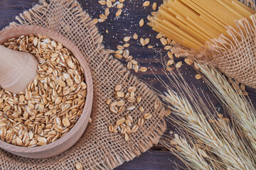 Woodem bowl with mortar filled with grain cereals.