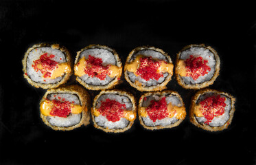 baked Japanese rolls with red caviar. top view