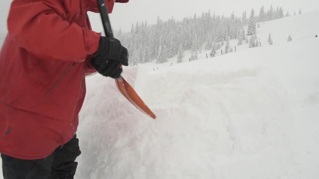 Snow igloo building in the high winter mountains