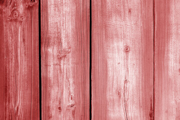 Wall made of uncutted weathered wood boards in red color.