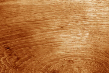 Old oak board texture as background with blur effect in orange tone.