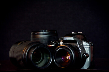 SLR camera and and telephoto lenses on black background