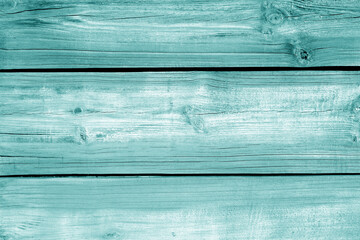 Wall made of uncutted weathered wood boards in cyan color.