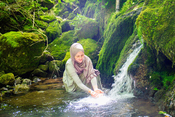 A young Muslim woman with hijab untouched nature, enjoys the natural resources, Paradise on Earth