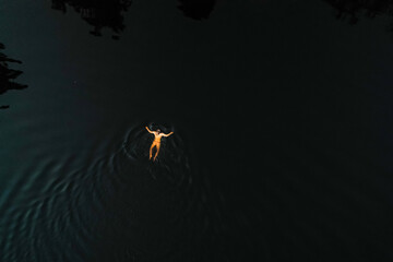 Woman swimming sunset