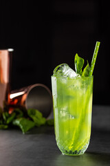 refreshing and light basil summer cocktail with ice cubes