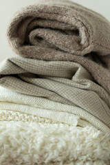 Pile of knitted sweaters. Warm background, knitwear, space for text. Autumn winter concept. Background with sweaters