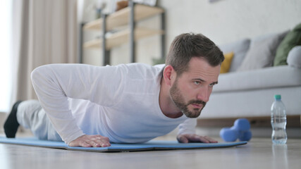 Close up of Mature Adult Man doing Pushups on Yoga Mat at Home