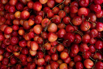 Cherry fruit background. Ripe organic berry on the market, colorful food texture. Top view, flat lay