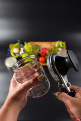 Obraz na płótnie Canvas Glass jar and canning key in hands. Homemade preservattion.