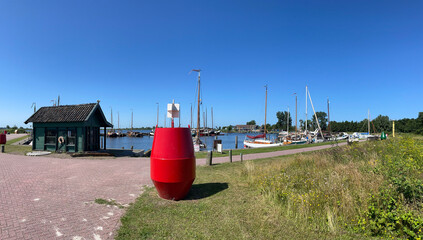 Fototapeta na wymiar Panorama from a red buoy in a harbor