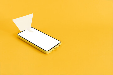 Blank grunge speech bubble paper and smart phone, on yellow background. Communication , network, social distancing concept.