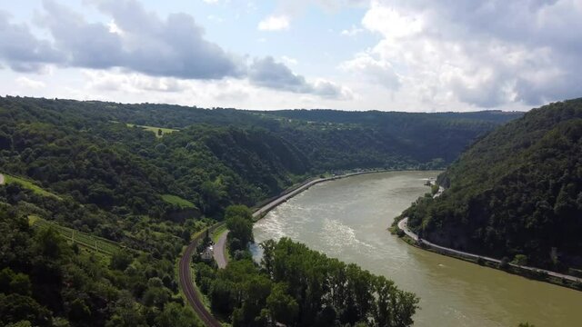 Video from a drone flying above the Rhine river in Germany, visible road on both sides of the river.