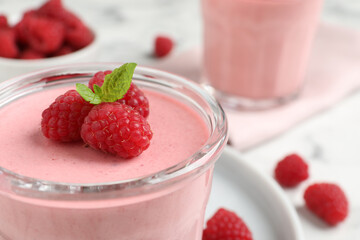 Glass of delicious raspberry mousse with mint, closeup. Space for text