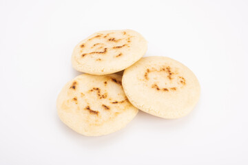 Stack of arepas made with corn flour on a white background, typical Latin American food. They are generally eaten in countries such as Venezuela