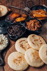 Table served with Venezuelan breakfast, arepas with different types of fillings such as caraotas,...