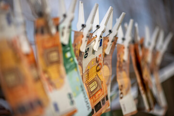 100 and 50 euro banknotes drying. Washed Euro paper bills. Drying euro on a string.Money laundering.