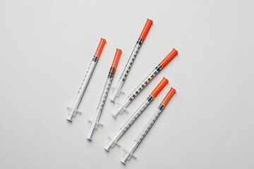 Disposable syringes on grey background, flat lay