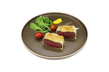 beef wellington with spinach and tomato isolated on white background