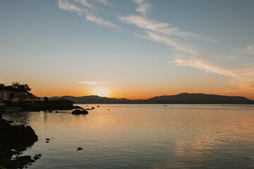 Fototapeta premium Beautiful sunrise in winter. Landscape with the sea being lit by the rising sun.
