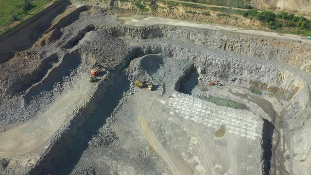 Quarry for the extraction of granite. Granite quarry. Extraction of granite. Open cast mine. mining industry. Stone Quarrying - Aerial view