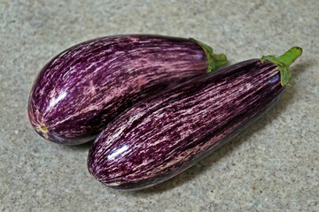 Striped eggplants on granite background