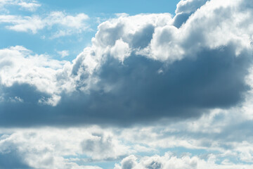 Cloudy fluffy sky natural background. Blue and white cloudscape.  Transition of gently cloud scape at summer day. Clean of birds, bugs, and dust.