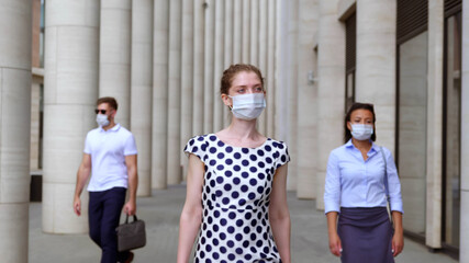 Diverse business people in face mask commute to work downtown