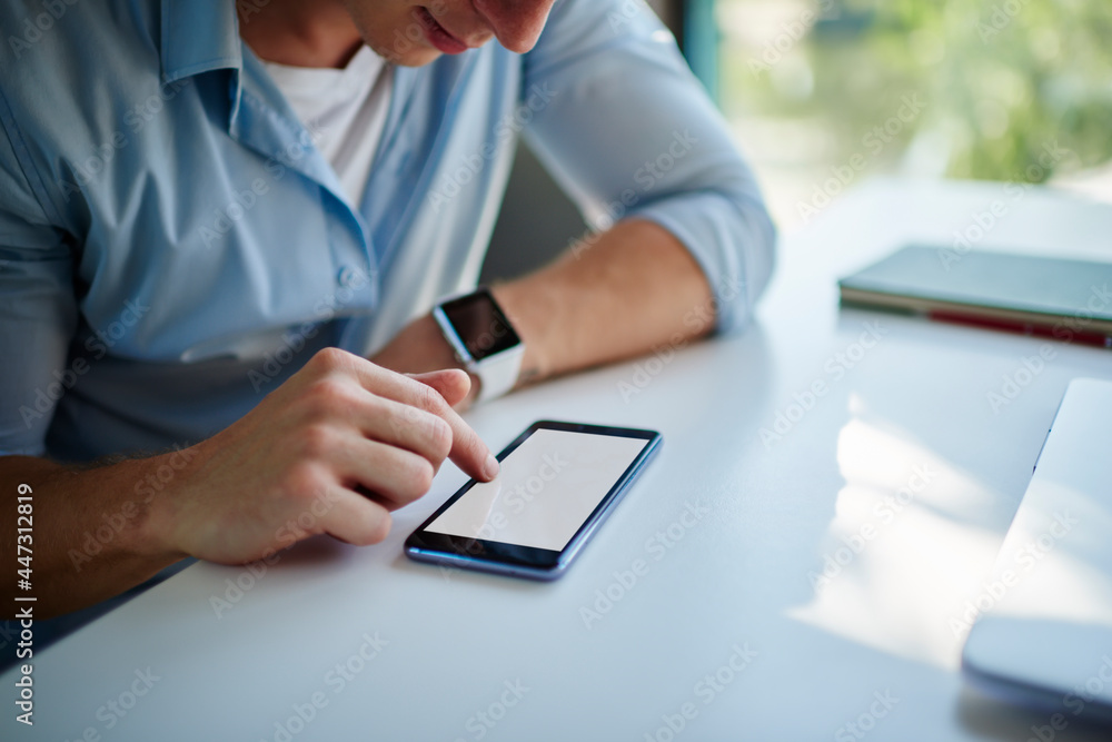 Poster unrecognizable male blogger touching mockup screen of smartphone gadget with blank copy space area f