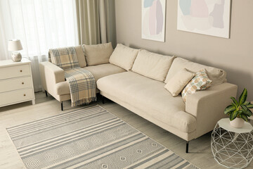 Living room interior with stylish rug and furniture, above view