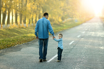 father and son walk in nature